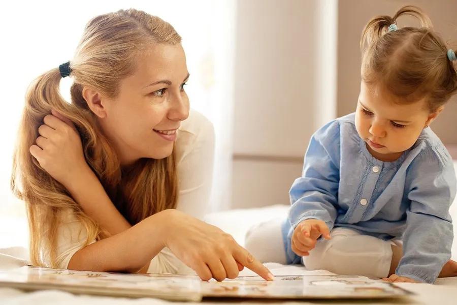Mother and daughter reading a book together