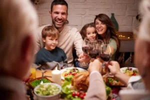 Family toasting at festive dinner table indoors