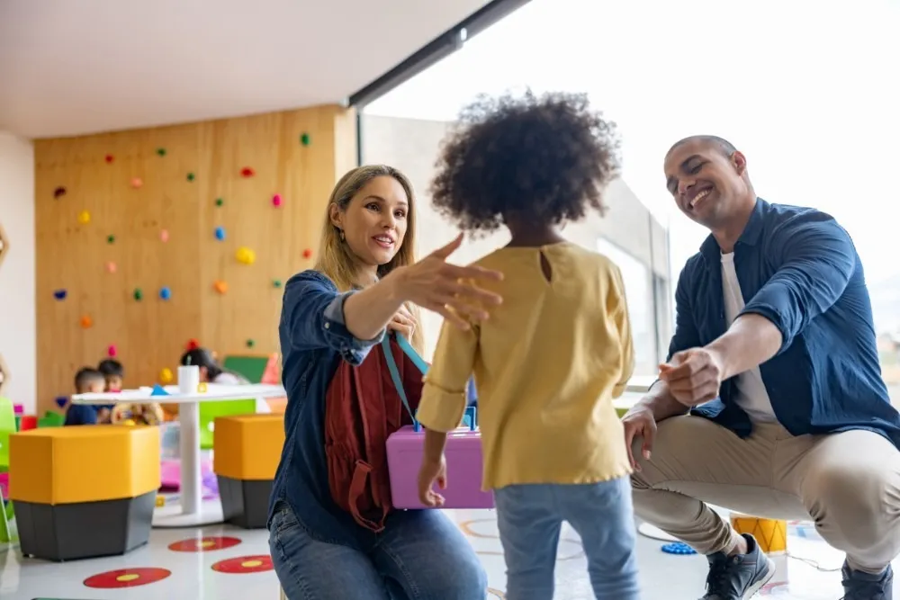  Parents greeting their child in a playroom
